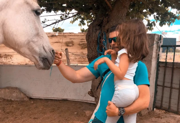 Ángel Cristo con su hija y un caballo