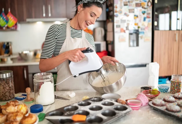 Pastelero mujer haciendo deliciosa crema para cupcakes