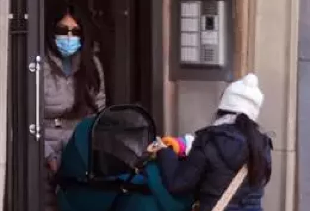 Gabriela Guillén subiendo el carrito de bebé a casa junto a su madre.