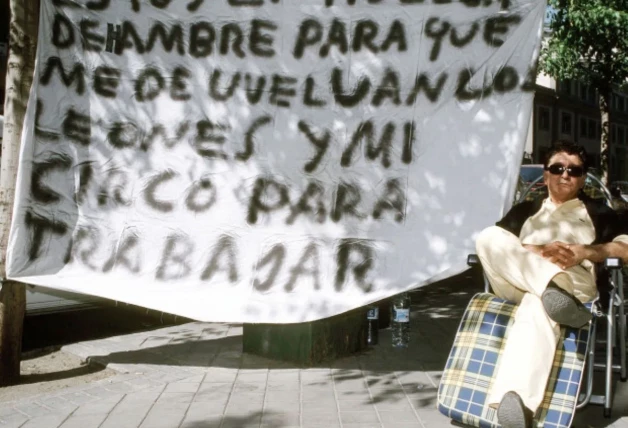 Ángel Cristo al lado de una pancarta durante una huelga de hambre