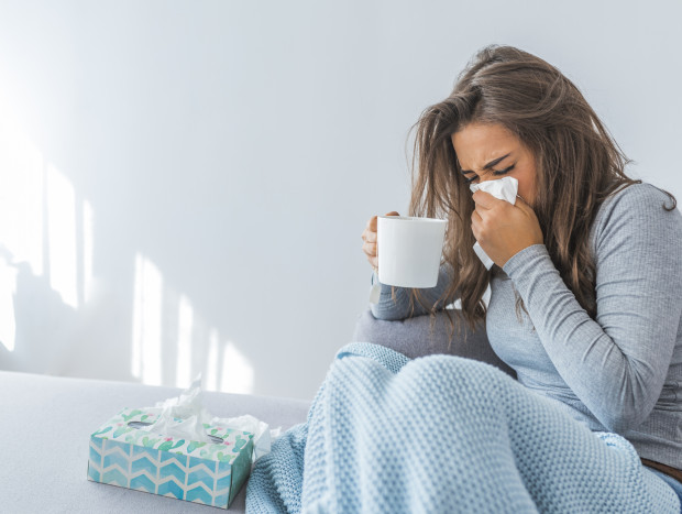 Cold And Flu. Portrait Of Ill Woman Caught Cold, Feeling Sick And Sneezing In Paper Wipe. Closeup Of Beautiful Unhealthy Girl Covered In Blanket Wiping Nose. Healthcare Concept. High Resolution