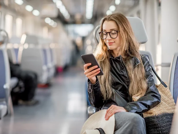 Chica joven viajando en tren.