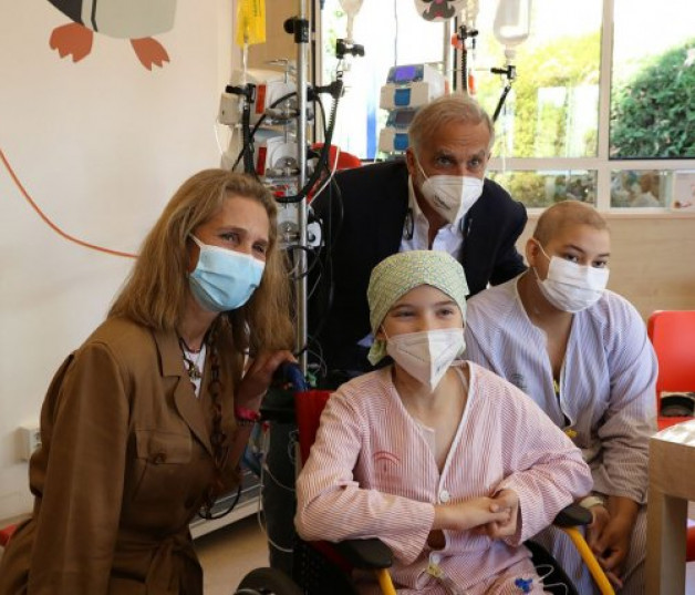 La infanta con el director de la asociación, Paco Arango, y dos pacientes.