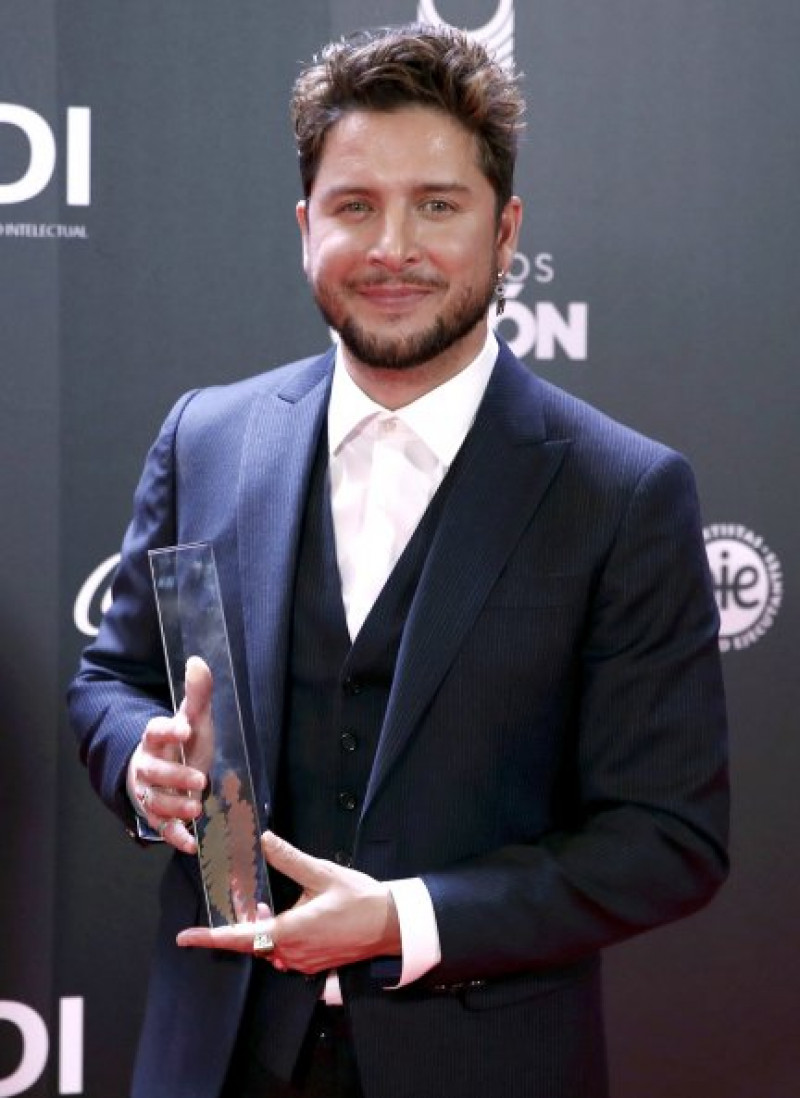 El cantante, posando orgulloso con su merecido premio.