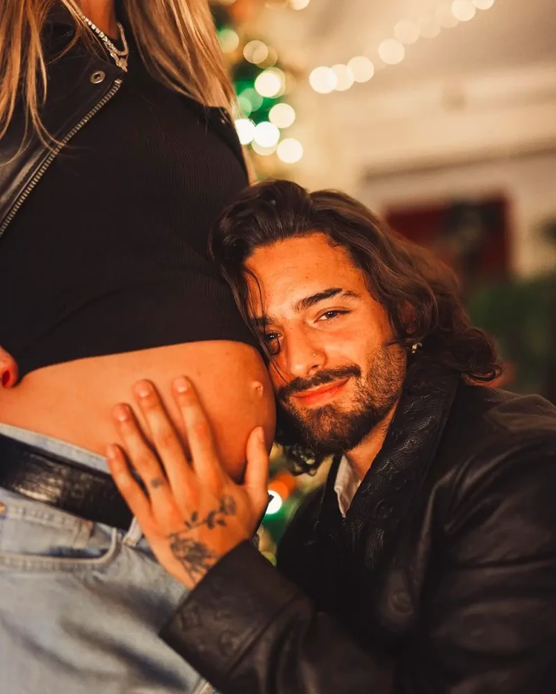 Maluma abrazando la barriga de su mujer embarazada.