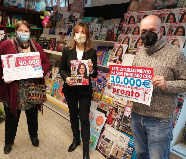 De izquierda a derecha, la ganadora, Asun García; Belén Noguerol, representante de la distribuidora, e Ismael Cortizas, propietario del punto de venta.