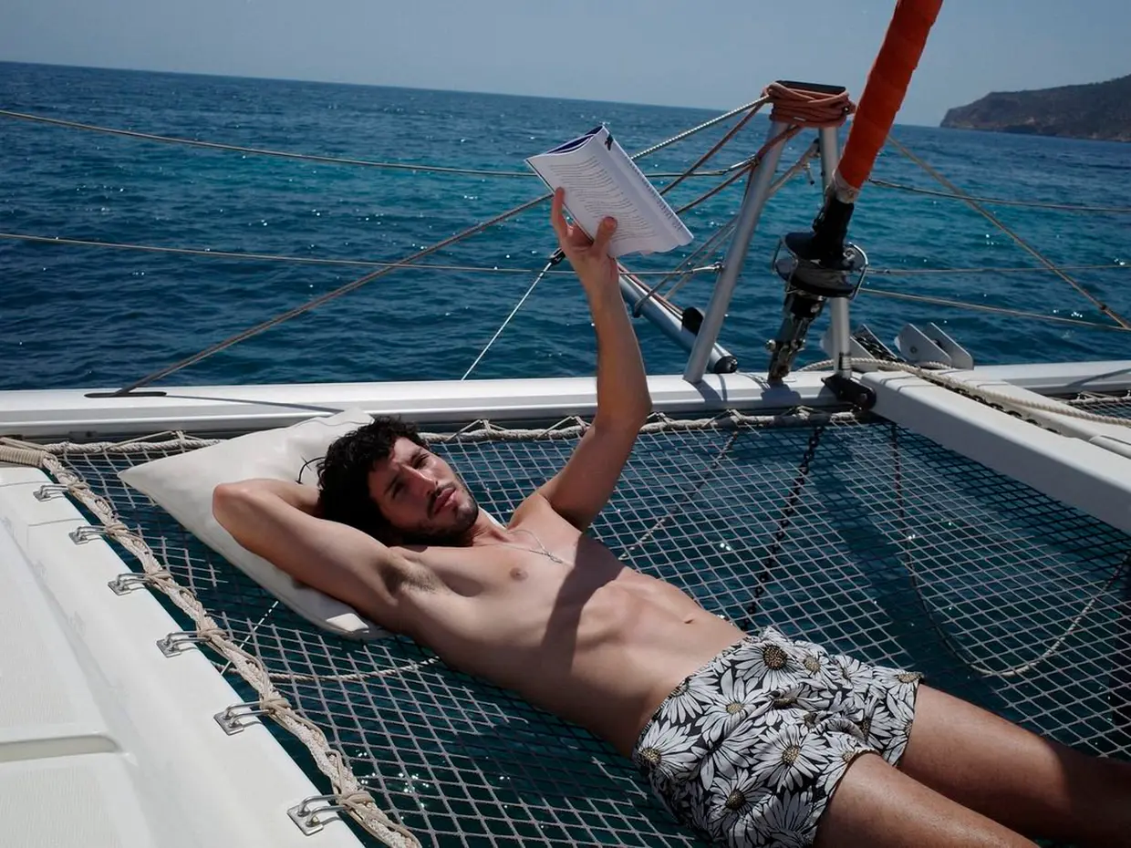 Sebastián Yatra leyendo en un barco