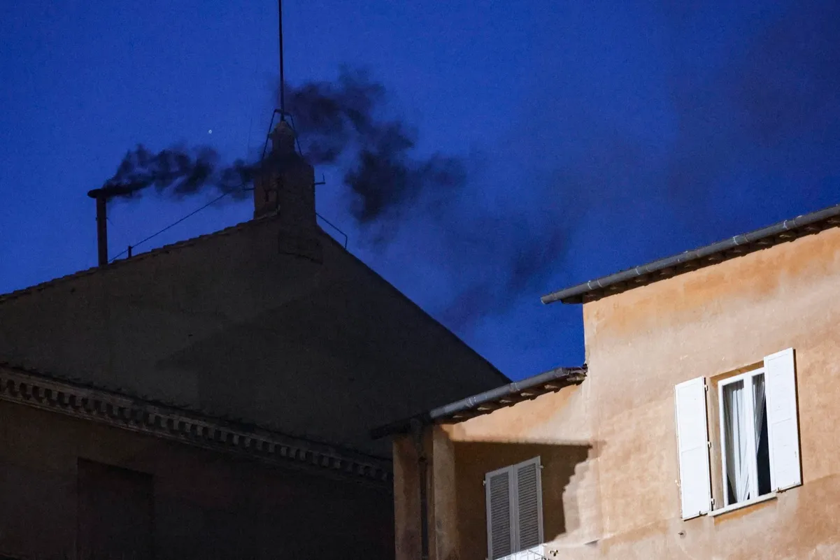 Sale humo negro de la chimenea del techo de la Capilla Sixtina en el primer día del cónclave para elegir a un nuevo papa en la Ciudad del Vaticano, 7 de mayo de 2025