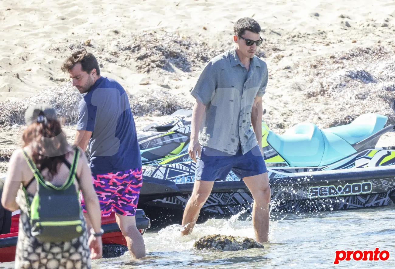 Álex González en la playa junto a unas motos de agua.